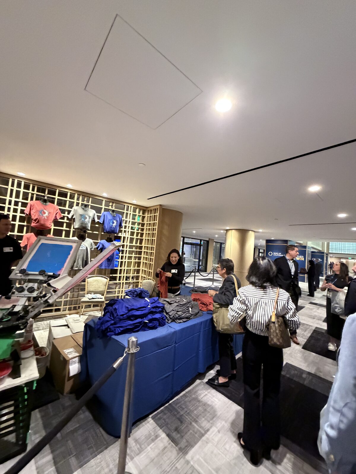 Guests lining up at a live printing station set up in a hotel lobby